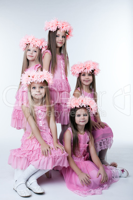Five little girls in pink dresses and wreaths