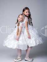 Two pretty little girls in white dresses