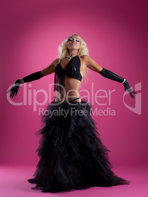Pretty blond woman dance in black arabian costume
