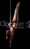 Strong blond woman posing on pole