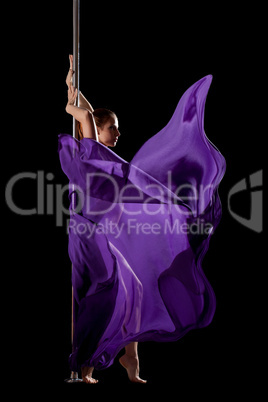 Woman posing in pole dance with fabric isolated