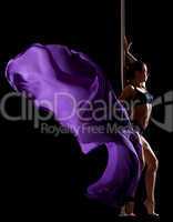 pretty woman posing with flying veil in pole dance