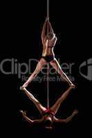 two women show high gymnastic level on pole dance