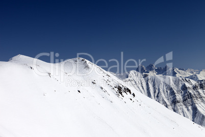 Snowy slope in high mountains