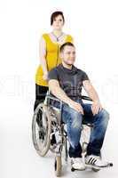 Man in wheelchair being pushed by woman