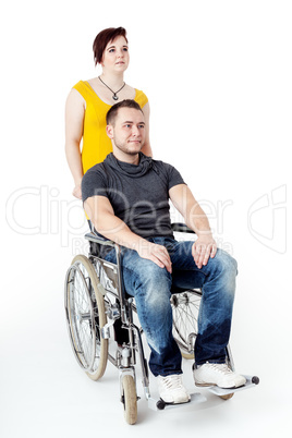 Man in wheelchair being pushed by woman