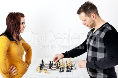 Man and woman playing chess