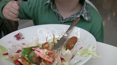 Little boy having lunch at a restaurant