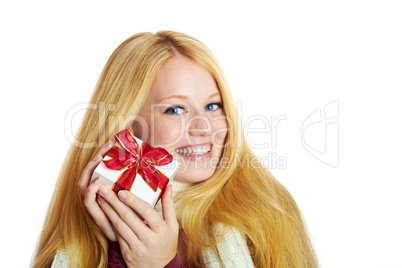 beautiful blonde woman holding a christmas gift is smiling