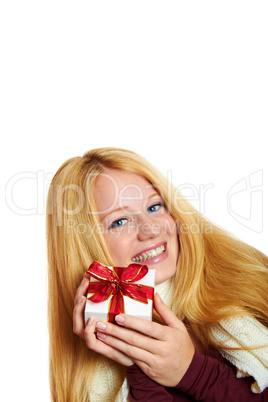 beautiful blonde woman holding a christmas gift is smiling