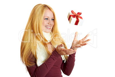 beautiful blonde woman catching a christmas gift is smiling