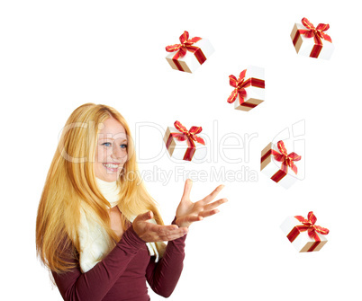 beautiful blonde woman catching a christmas gift is smiling