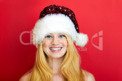 beautiful blonde woman holding a christmas gift is smiling