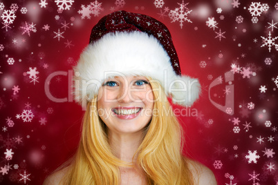 beautiful blonde woman holding a christmas gift is smiling