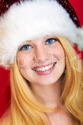 beautiful blonde woman holding a christmas gift is smiling