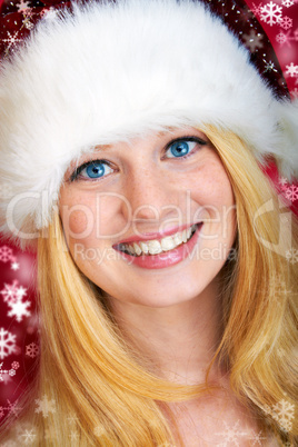 beautiful blonde woman holding a christmas gift is smiling