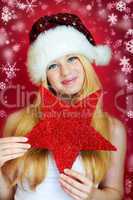 beautiful blonde woman holding a christmas gift is smiling