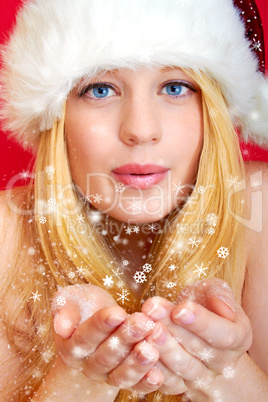 beautiful blonde woman blowing snow