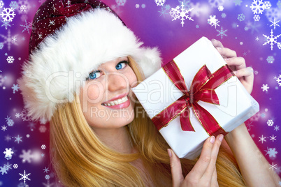 beautiful blonde woman holding a christmas gift is smiling