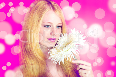 portrait of a young beautiful blonde girl with white flower