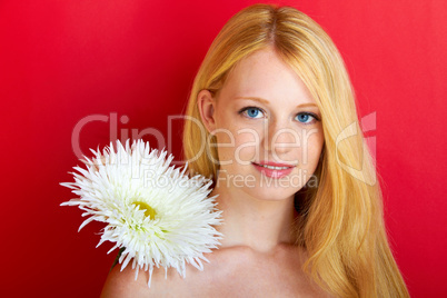 portrait of a young beautiful blonde girl with white flower