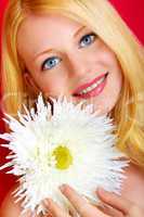 portrait of a young beautiful blonde girl with white flower