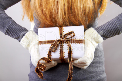 beautiful blonde woman holding a christmas gift is smiling