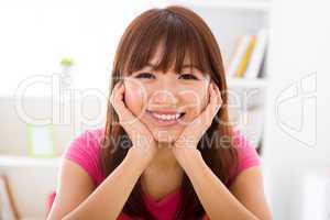 Asian girl holding her face