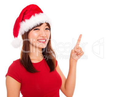 Christmas girl pointing on blank space