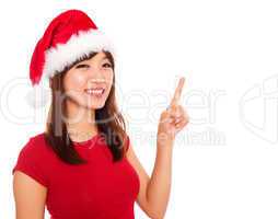 Christmas girl pointing on blank space