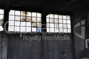 windows and concrete wall in factory interior