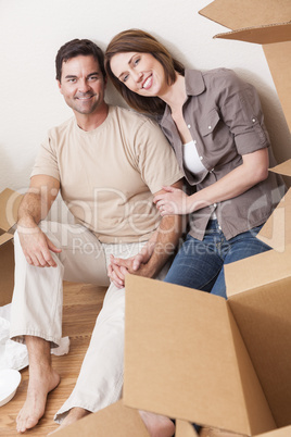 Happy Couple Unpacking or Packing Boxes Moving House