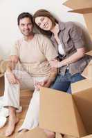 Happy Couple Unpacking or Packing Boxes Moving House