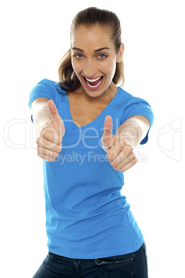 Overjoyed woman showing double thumbs up
