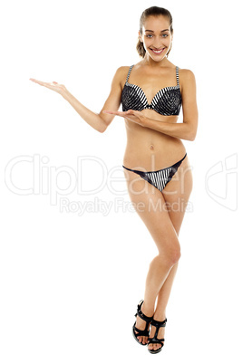 Glamorous bikini woman presenting copy space area