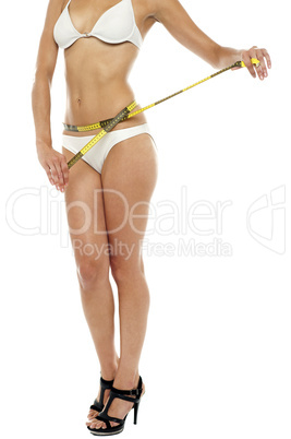Female model with a inch tape around her waist