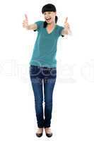 Amused woman gesturing double thumbs up