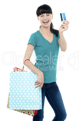 Shopaholic woman holding her cash card up