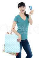 Shopaholic woman holding her cash card up