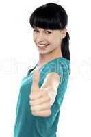 Attractive woman showing thumbs up gesture