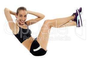 Fit woman in sporty attire doing crunches