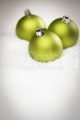 Green Christmas Ornaments on Snow Flakes with Text Room