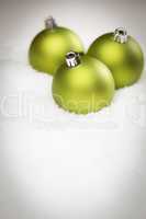 Green Christmas Ornaments on Snow Flakes with Text Room