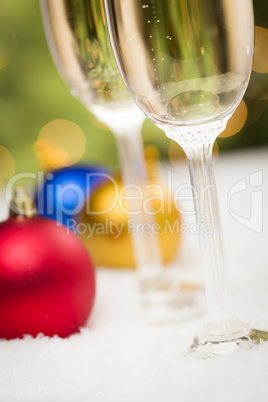 Christmas Ornaments and Champagne Glasses on Snow