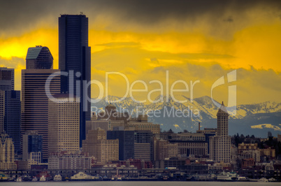Downtown Seattle with dramatic sky and Cascade Mountains in the