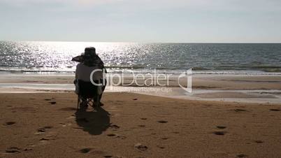 Senior man sitting at beach