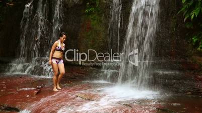 sexy woman passing through waterfall