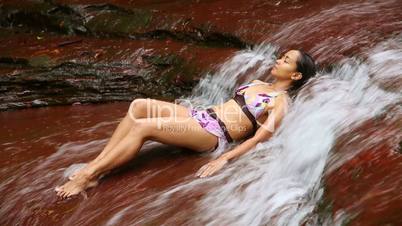 sexy girl lying down in river