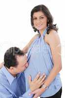 Father kissing pregnant belly of wife. Concept of love, over whi