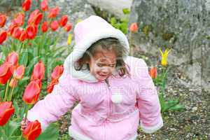 cute girl cut bouquet of red tulips on spring